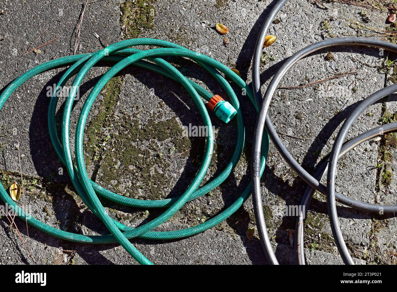 Garden rubber hoses on the ground Stock Photo