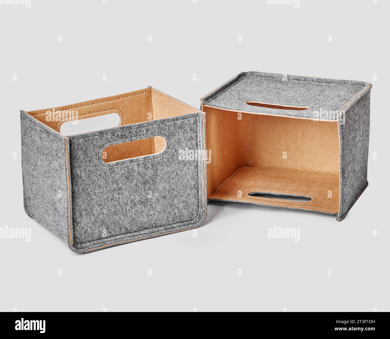 Two handcrafted felt boxes with slotted handles for storing things Stock Photo