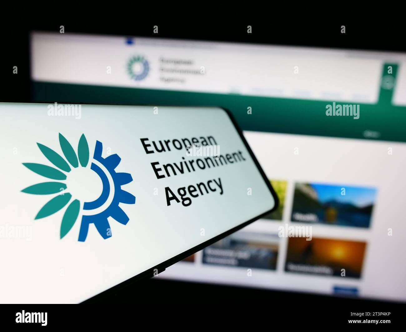 Smartphone with logo of EU institution European Environment Agency (EEA) in front of website. Focus on center-left of phone display. Stock Photo