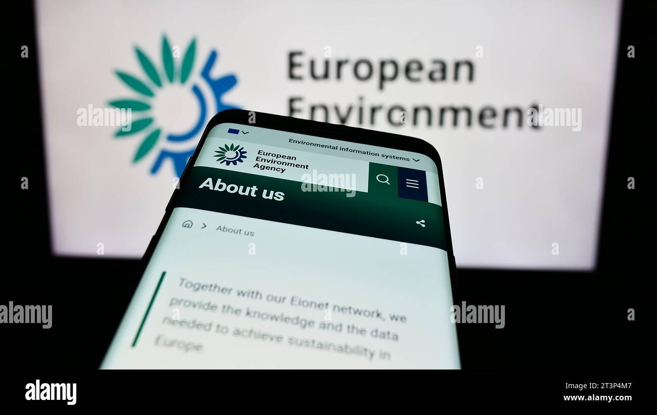 Mobile phone with website of EU institution European Environment Agency (EEA) in front of logo. Focus on top-left of phone display. Stock Photo