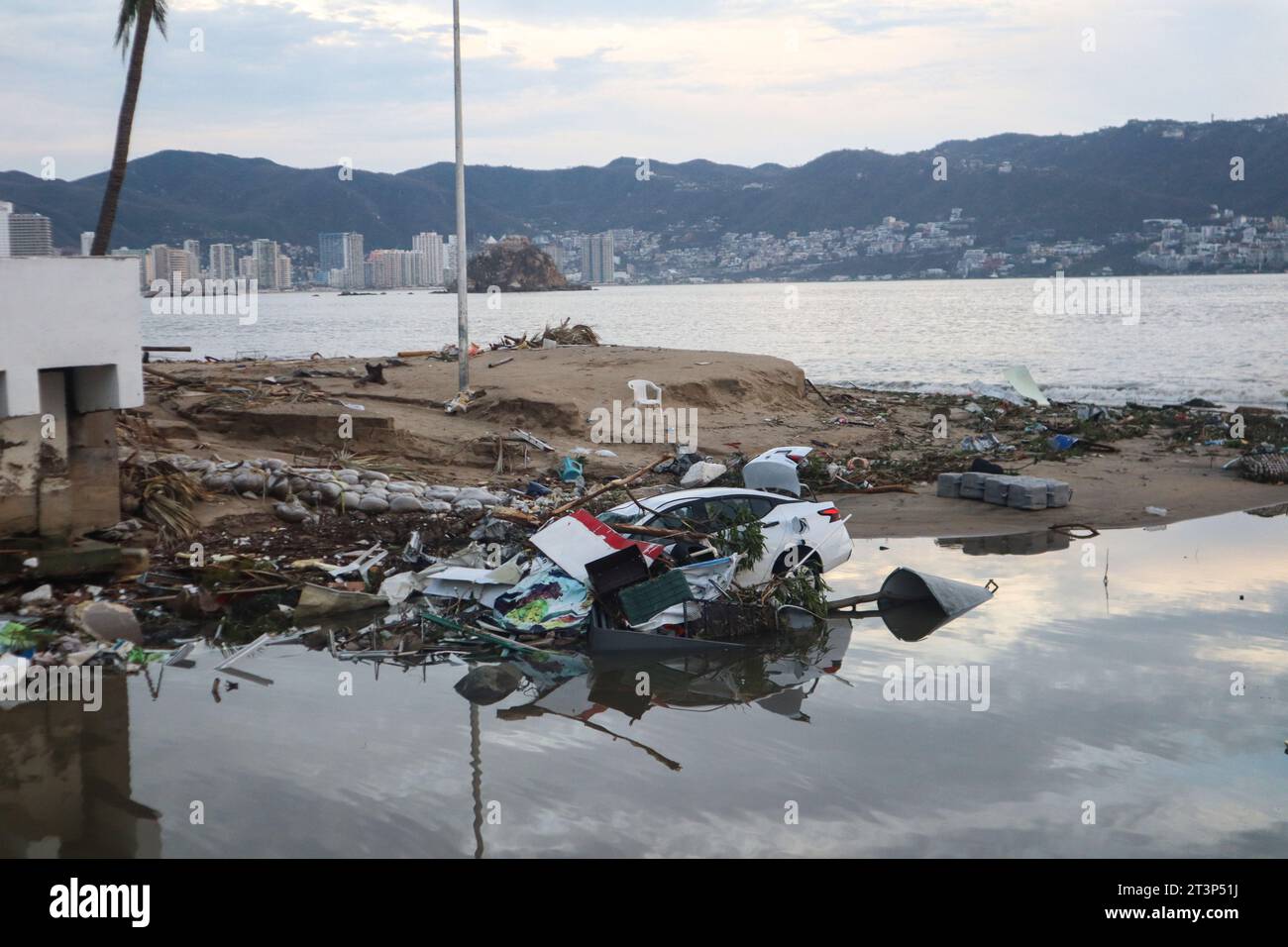 Acapulco, Mexico. 25th Oct, 2023. A car lies under debris on the coast ...