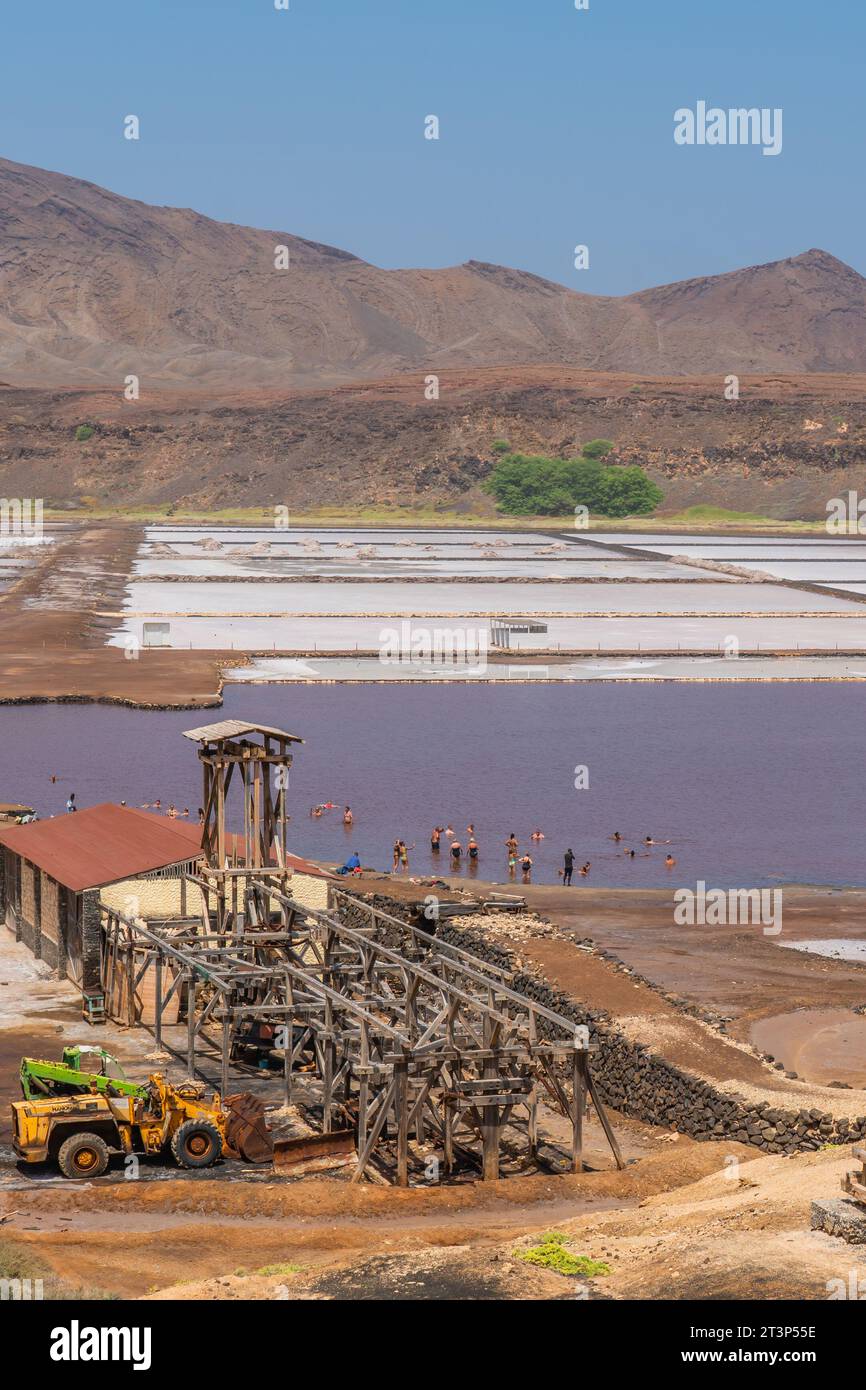 Building at the Salinas de Pedra de Lume, old salt lakes with people ...