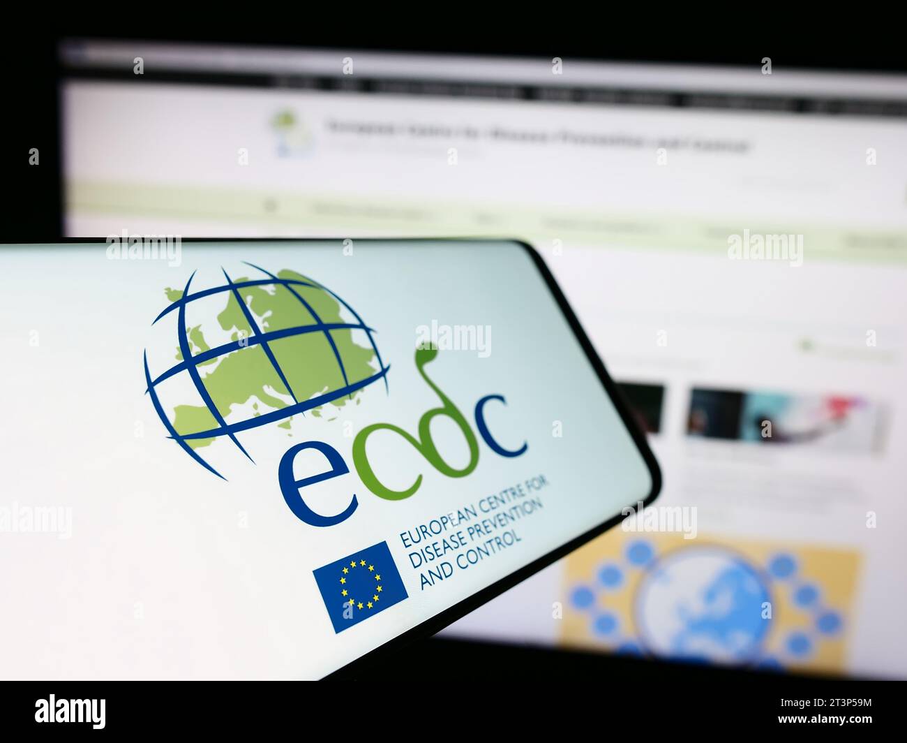 Mobile phone with logo of European Centre for Disease Prevention and Control (ECDC) in front of website. Focus on center-left of phone display. Stock Photo