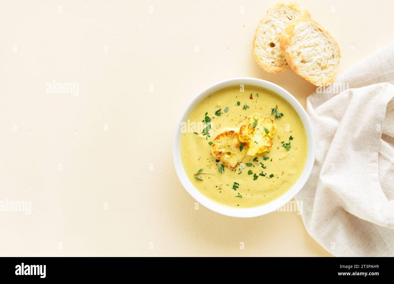 Cauliflower cheese soup in bowl over light background with copy space. Vegetarian or healthy diet food concept. Top view, flat lay Stock Photo