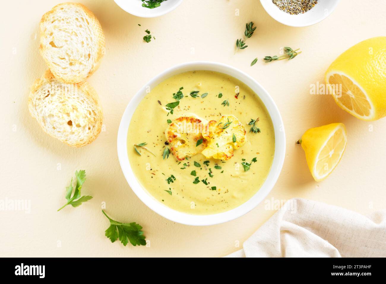 Cauliflower cheese soup in bowl over light background. Vegetarian or healthy diet food concept. Top view, flat lay Stock Photo