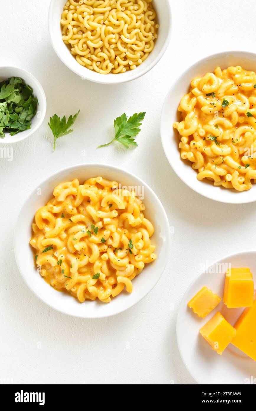 Macaroni and cheese in bowl over white background. Top view, flat lay Stock Photo