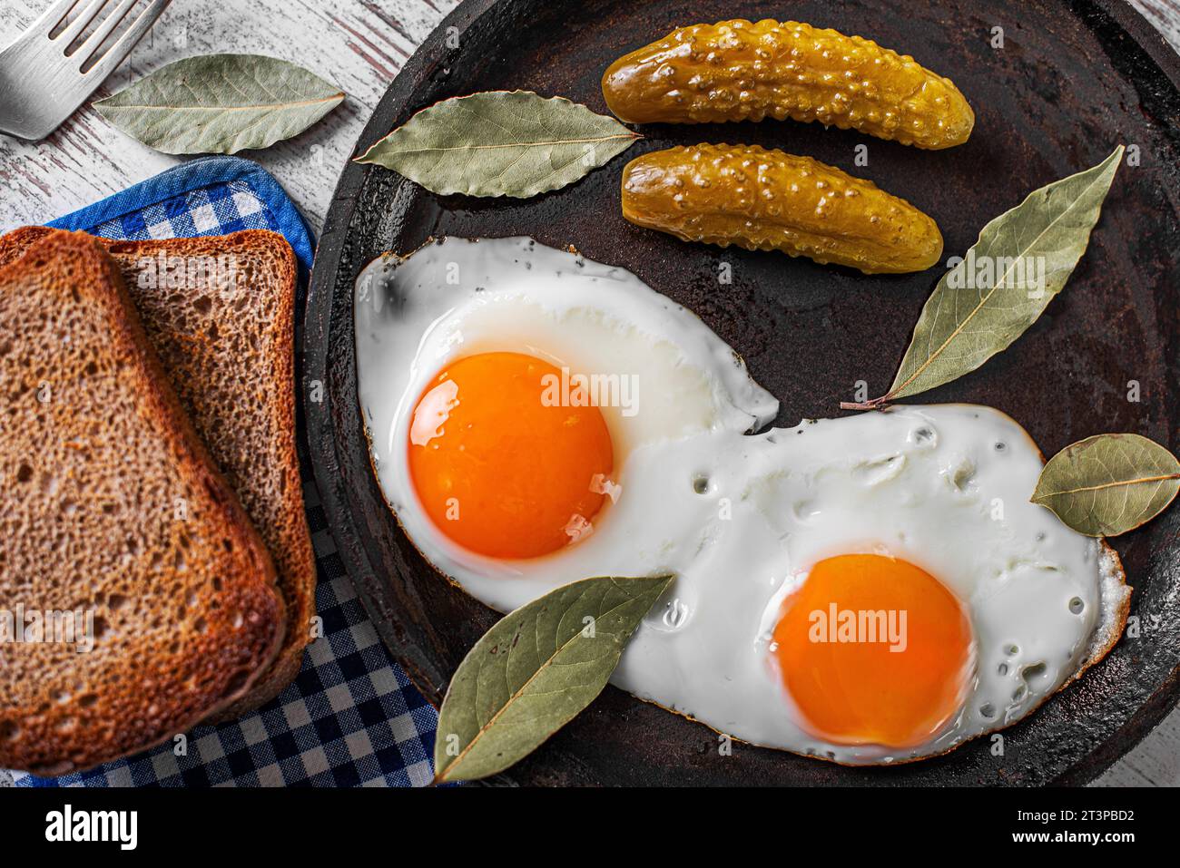 Premium Photo  Scrambled, frying eggs from one egg in a small pan on  kitchen table