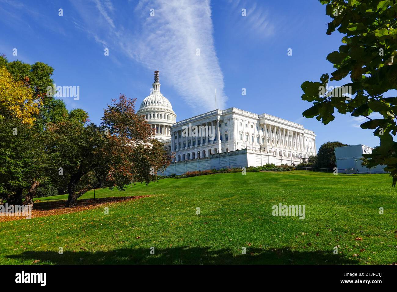 United States Capitol building and grounds in autumn, House of Representatives wing with dome, vapor trail, contrail, overhead, Washington, DC, USA. Stock Photo