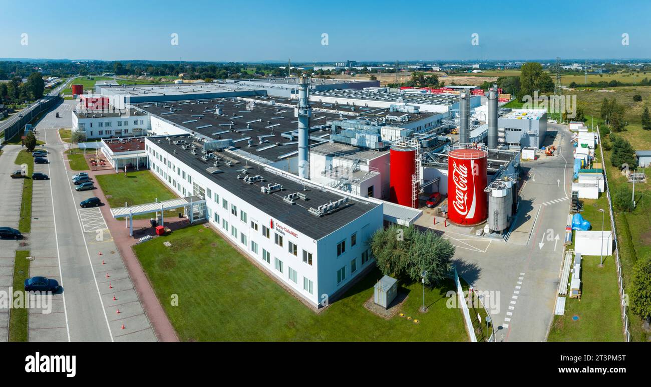 Staniątki, Poland - September 9, 2023: Coca Cola factory near Krakow in Poland. Big production plant. Great buildings and big red containers with comp Stock Photo