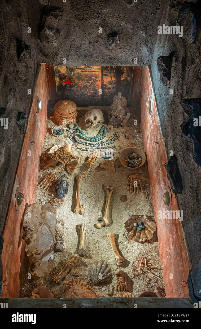 Guatemala, La Antigua - July 20, 2023: Jade Maya Museum. Mayan tomb replica with human bones and skull, sea shells and jade jewelry Stock Photo