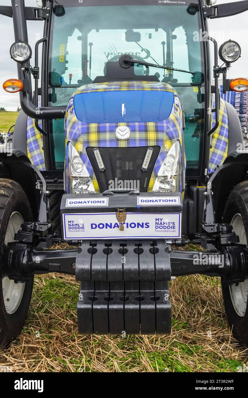 New Holland T4.75 tractor, decorated in the MND, My Name's Doddie Foundation tartan, a charity set up in the name of Doddie Weir, on display Stock Photo