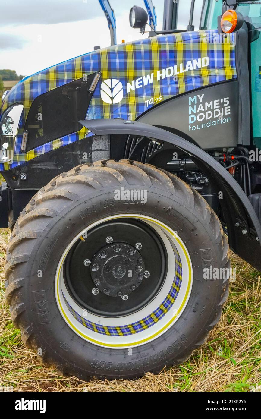 New Holland T4.75 tractor, decorated in the MND, My Name's Doddie Foundation tartan, a charity set up in the name of Doddie Weir, on display Stock Photo