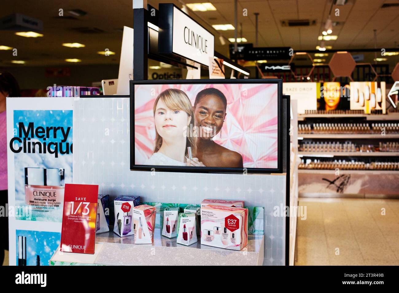 Inclusive cosmetics Christmas advertising for the Clinique brand on TV screen in Boots chemist - Merry Clinique 2023 Stock Photo