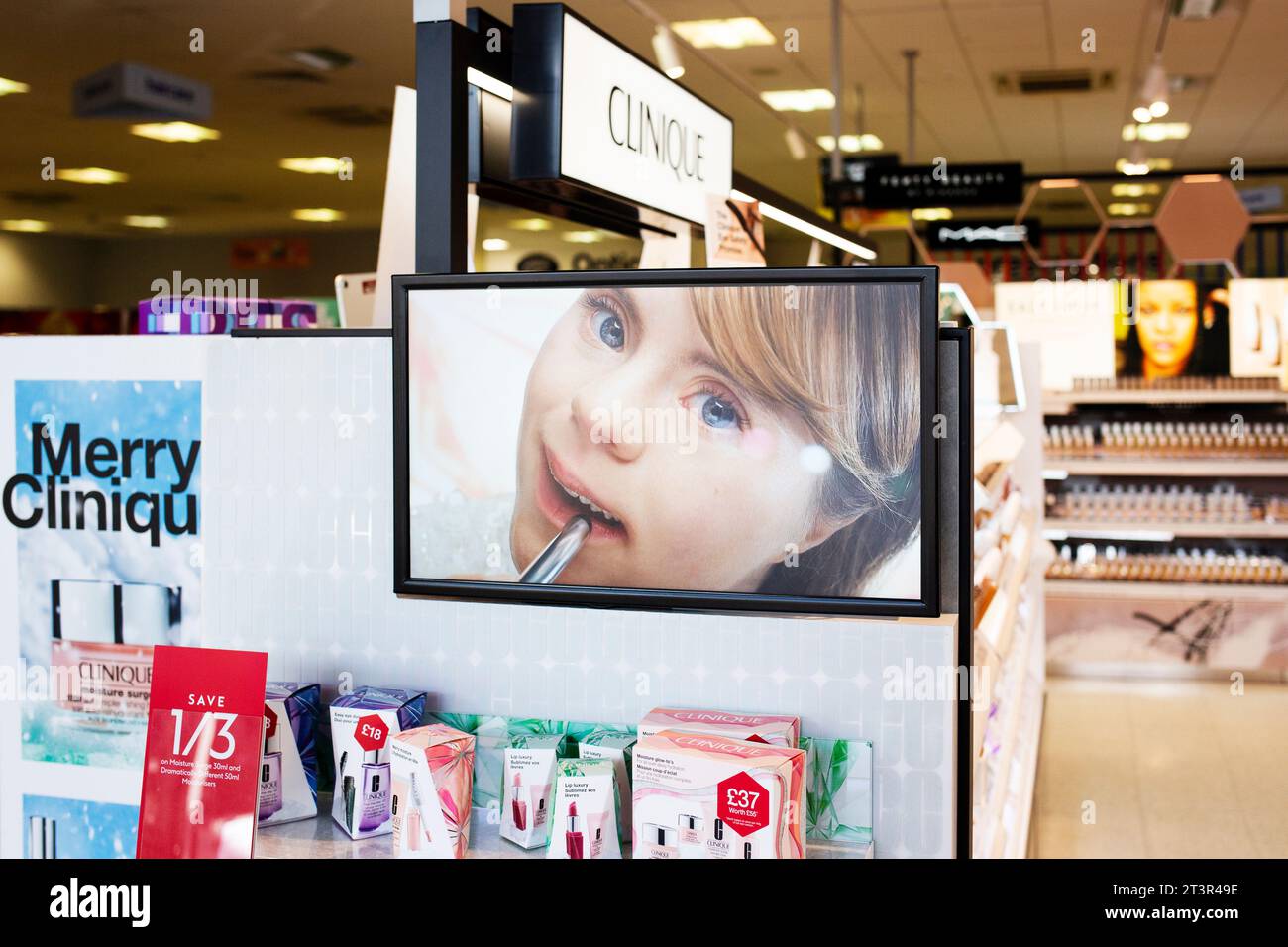 Inclusive cosmetics Christmas advertising for the Clinique brand on TV screen in Boots chemist - Merry Clinique 2023 Stock Photo