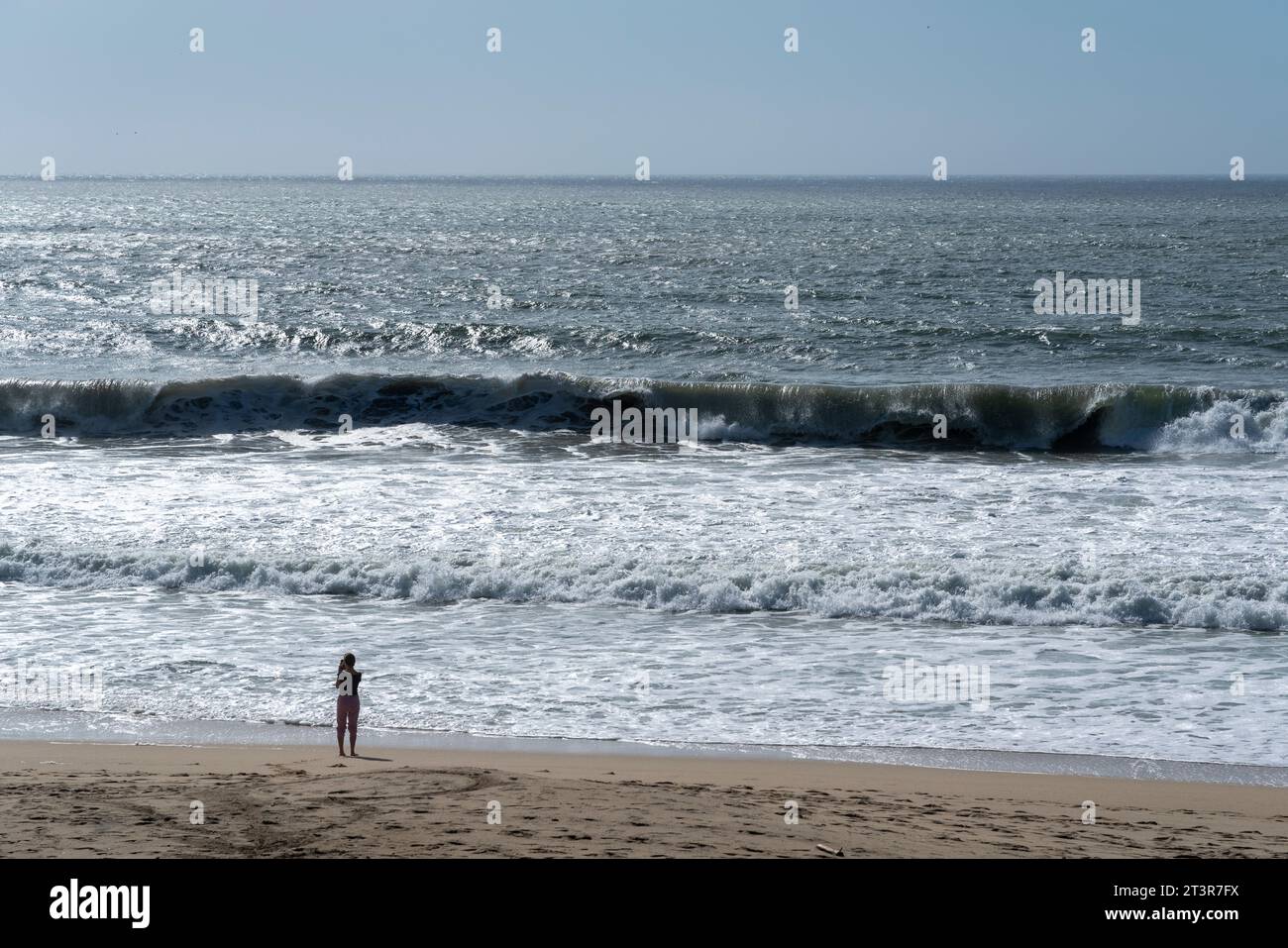 Beach goer takes photo at Francis Beach near Half Moon Bay, California Stock Photo