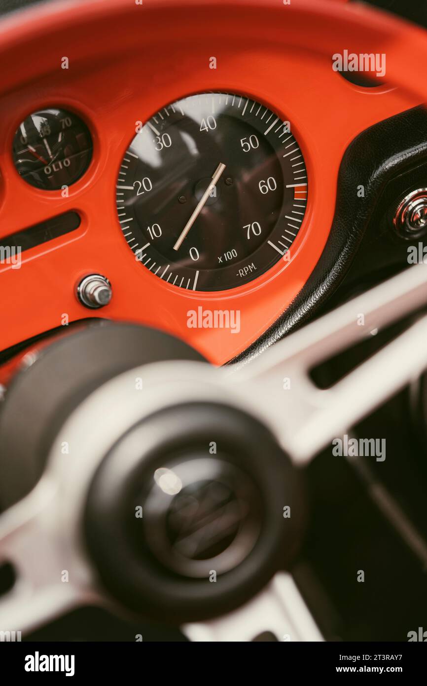 Close up hot of a vintage dashboard with various gauges on a retro car
