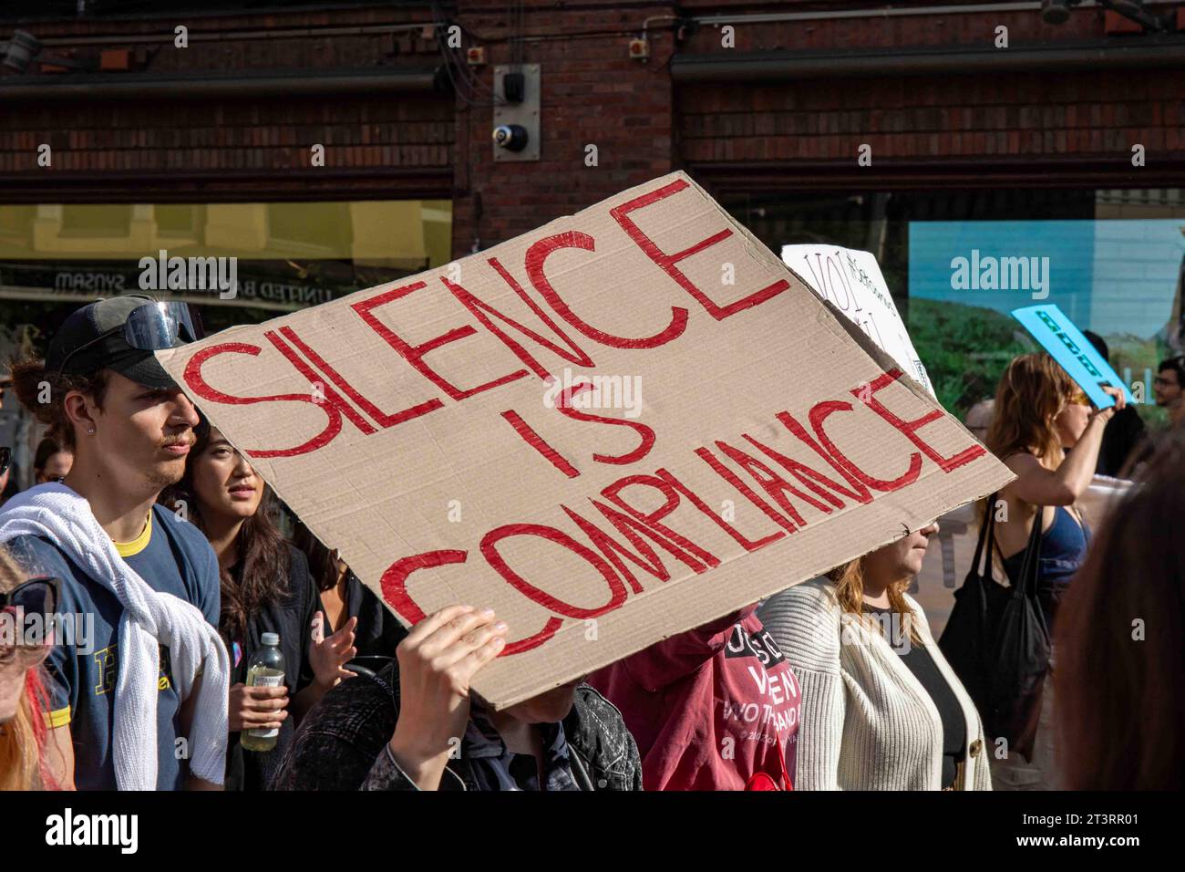 Silence is compliance. Protester holding a hand-written cardboard sign at Me emme vaikene! anti-racism demonstration in Helsinki, Finland. Stock Photo