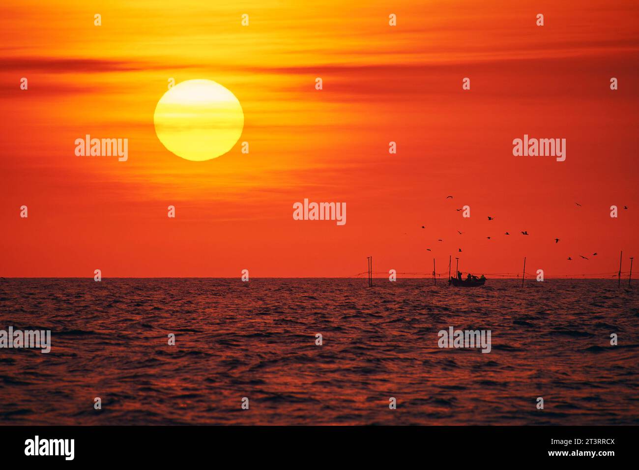 sunrise with a fishing boat on the Black Sea Stock Photo - Alamy