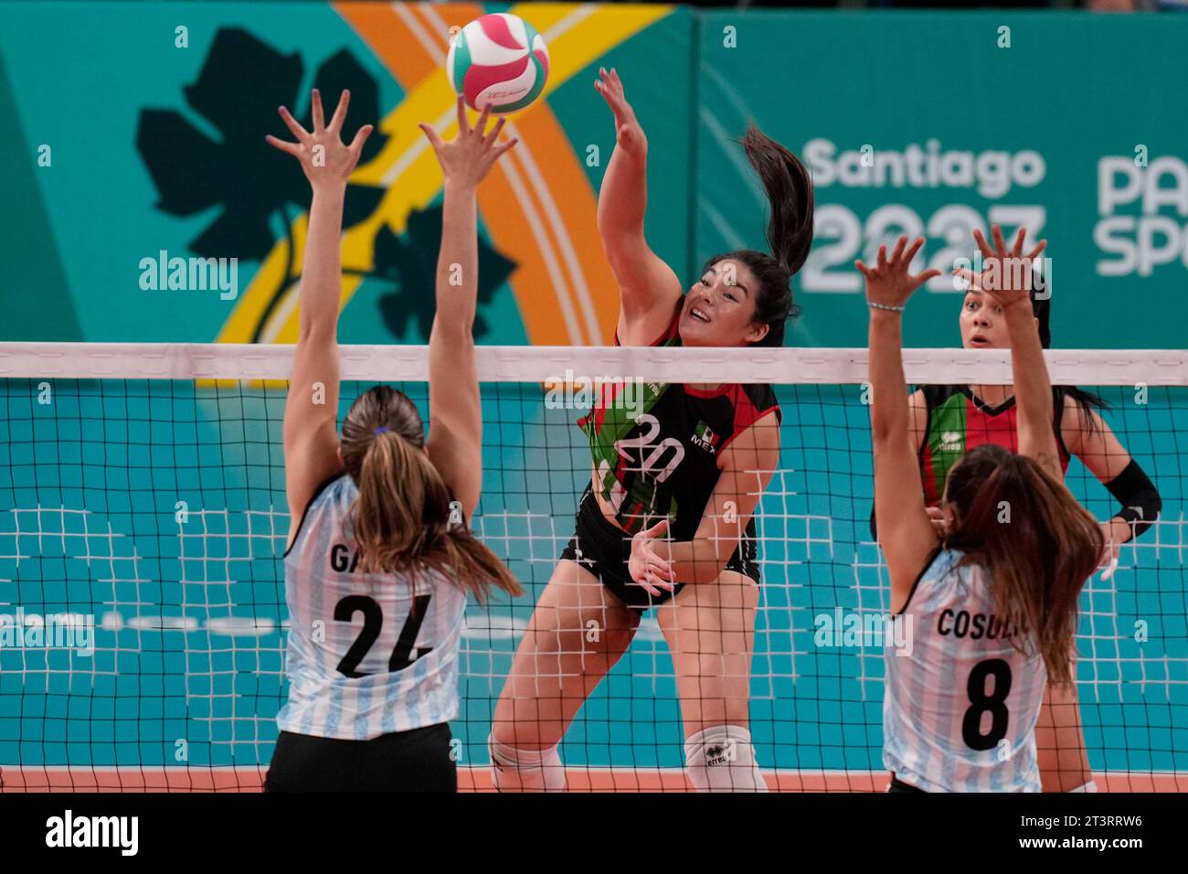 Mexico's Aime Topete, center, spikes the ball against Argentina during