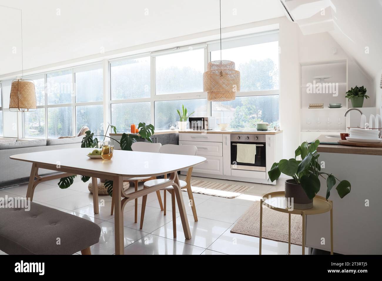 Interior of light kitchen with dining table and counters Stock Photo ...