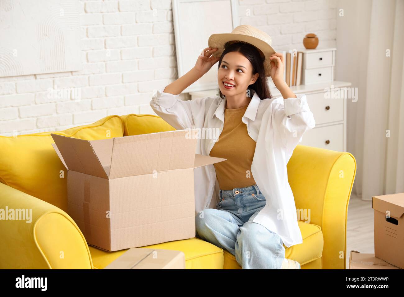 Young Asian woman with new hat from parcel box at home Stock Photo - Alamy