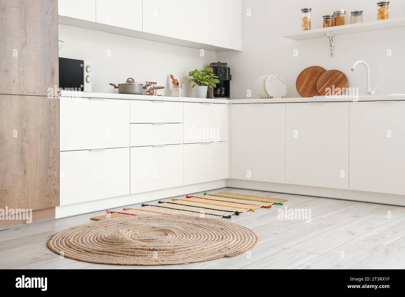 Interior of light kitchen with counters and carpets Stock Photo - Alamy
