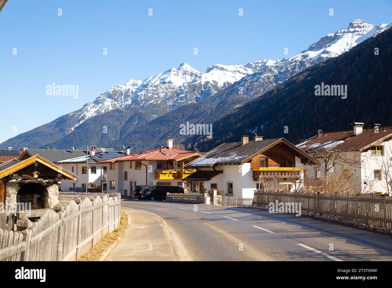 Alps village with snow mountain in the background Stock Photo - Alamy