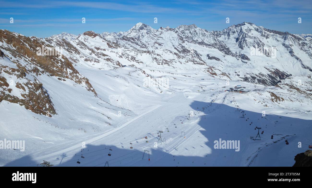 panoramic view of Alps mountain snowy range with skiing trails, Stubai Glacier Stock Photo
