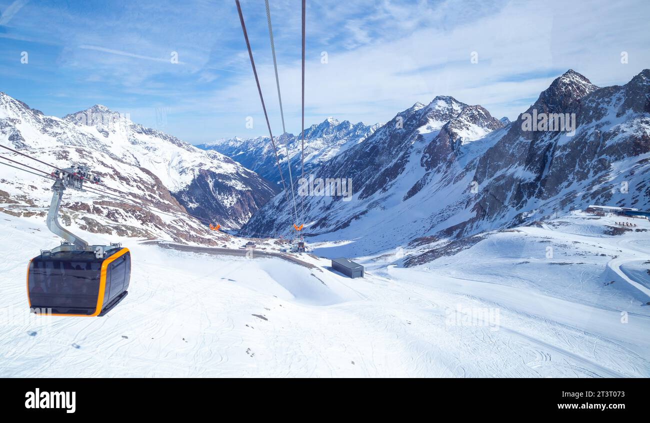 Cable car in the background of winter Alps snowy mountain range, Neustift im Stubaital, Austria Stock Photo