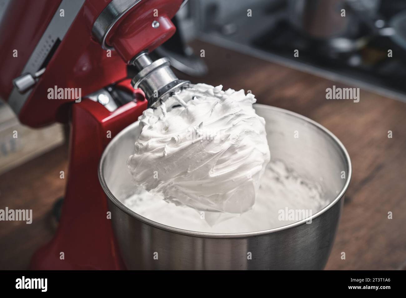 Whipped egg whites - beaten italian meringue on a wire whisk closeup Stock Photo