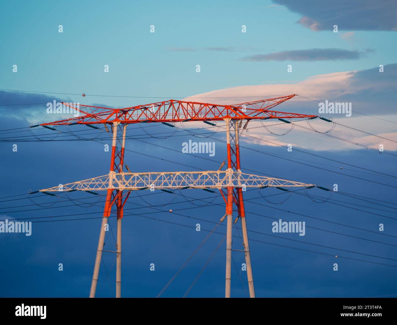 Hight voltage electric towers during sunset. Stock Photo