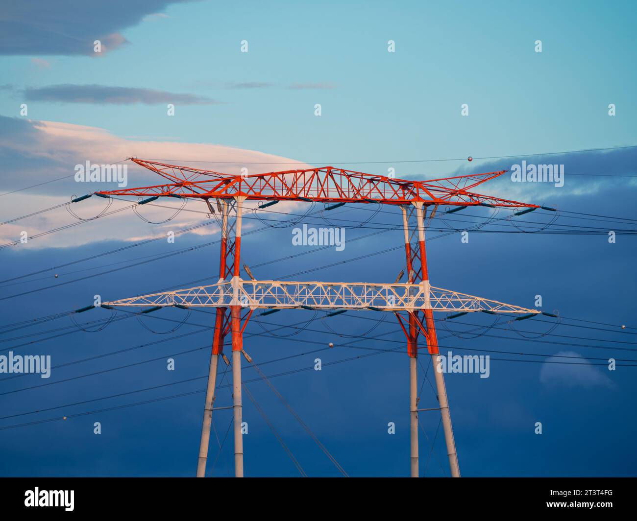 Hight voltage electric towers during sunset. Stock Photo