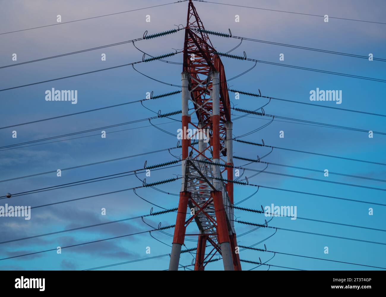 Hight voltage electric towers during sunset. Stock Photo