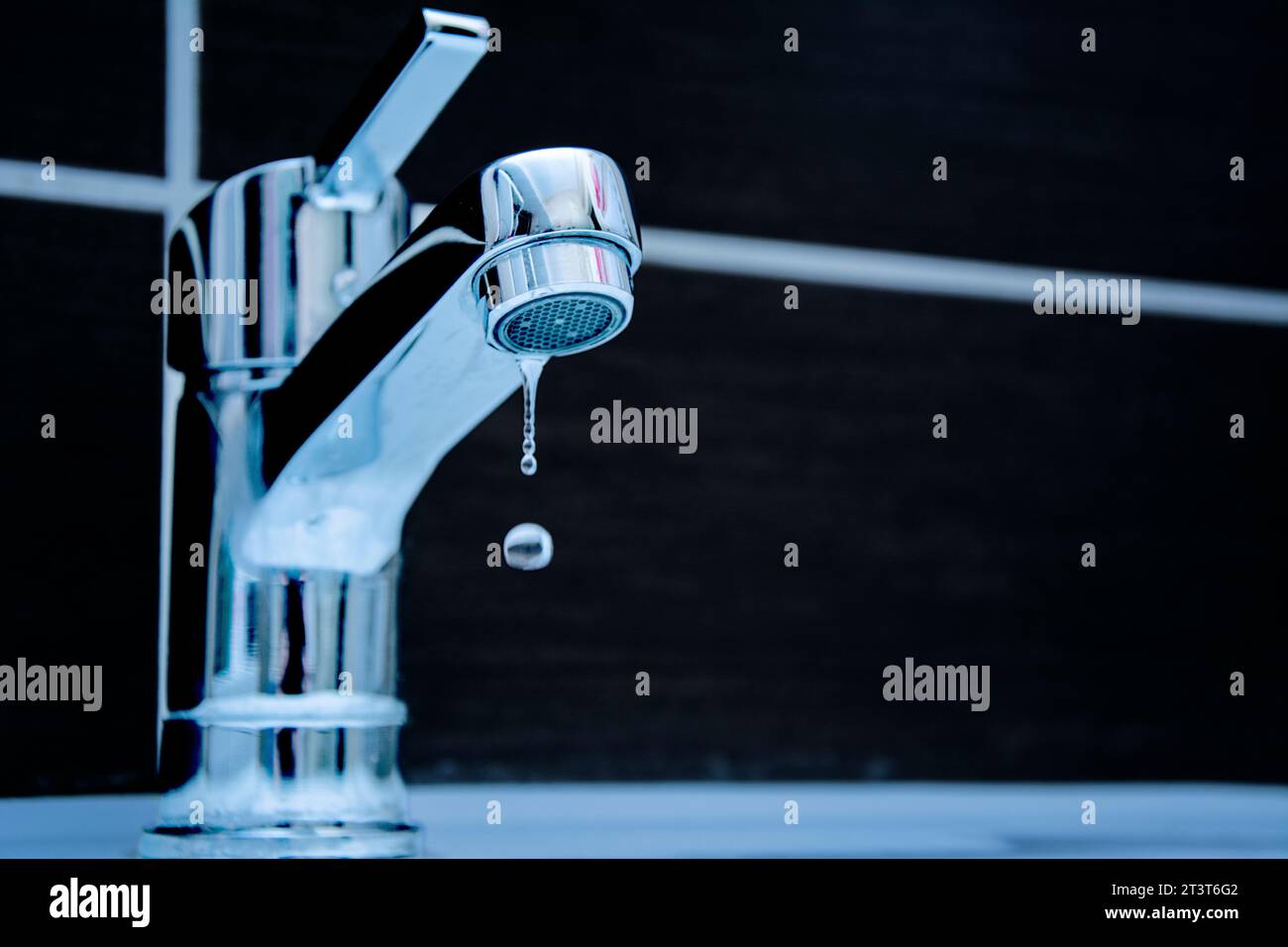 Drop of water from a leaky faucet close-up Stock Photo