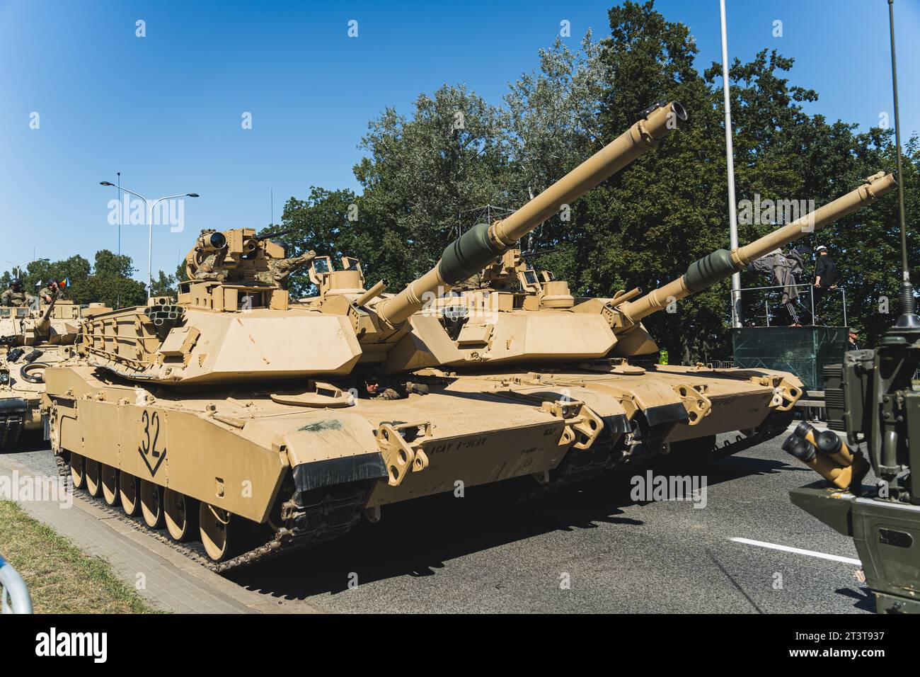 Focus on two M1 Abrams main battle tanks driving in a column during an