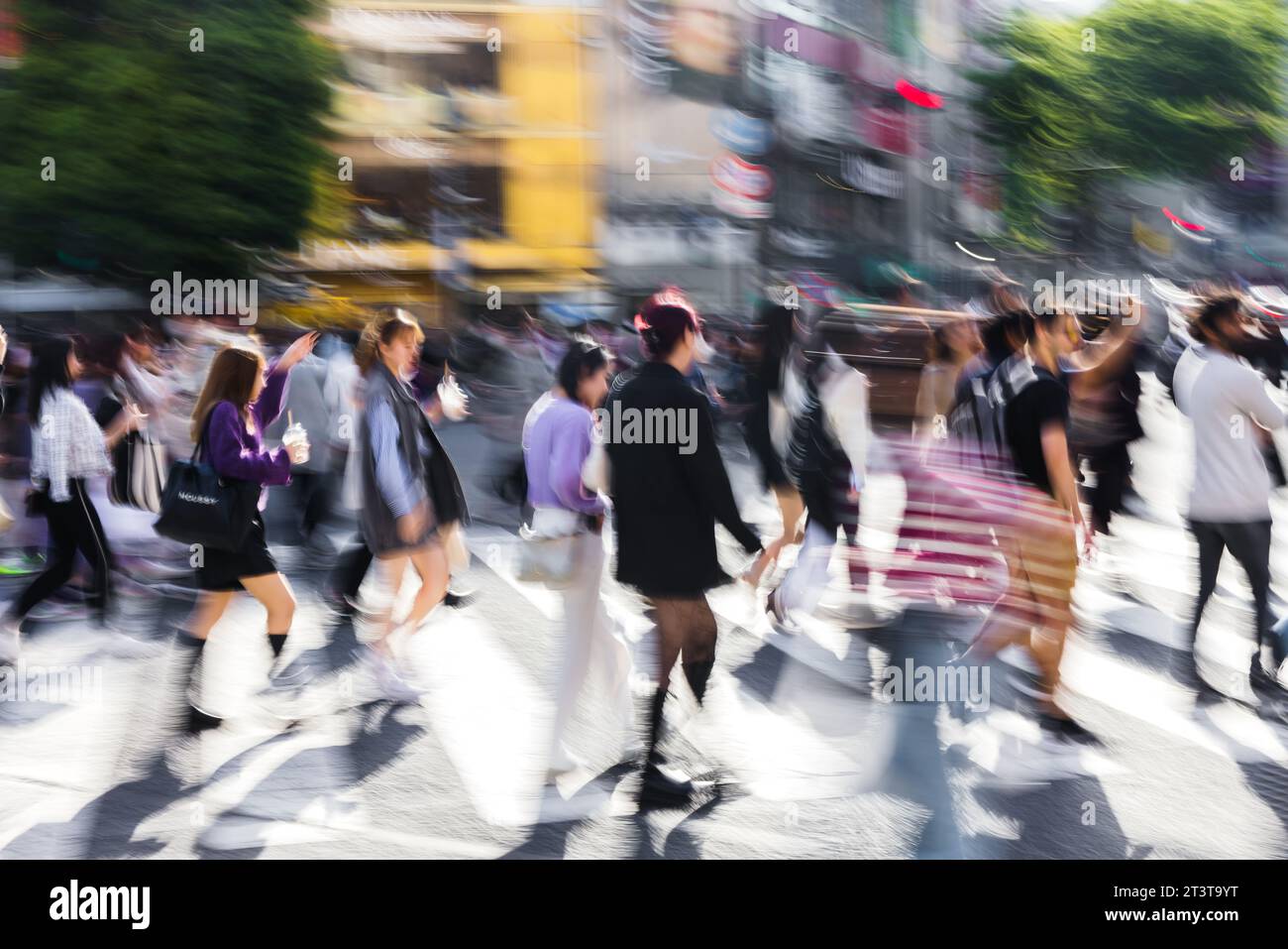 picture with motion blur effect of crowds of people crossing the famous ...