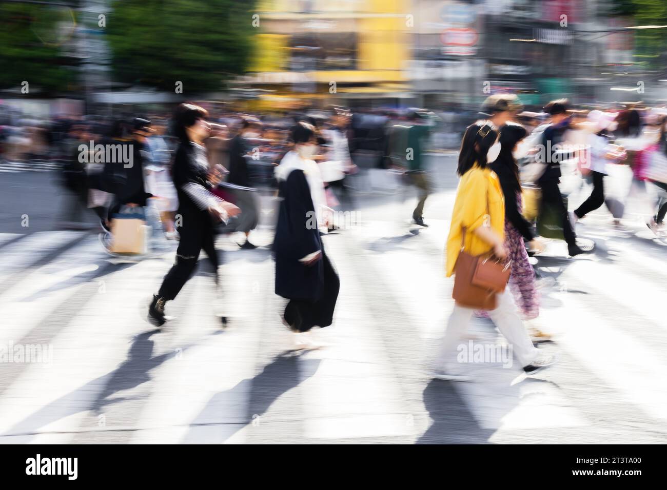 picture with motion blur effect of crowds of people crossing the famous ...