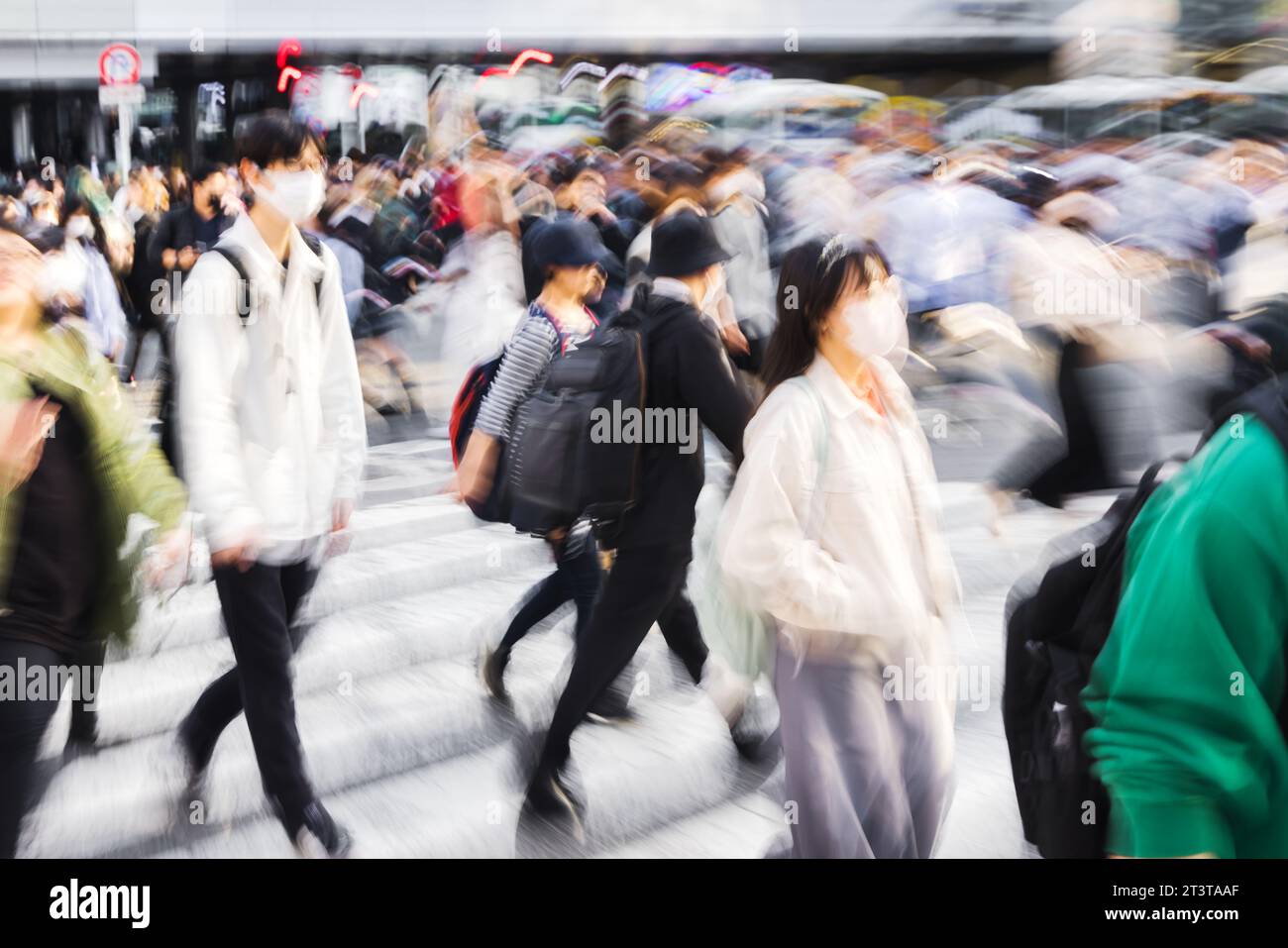 picture with motion blur effect of crowds of people crossing the famous ...