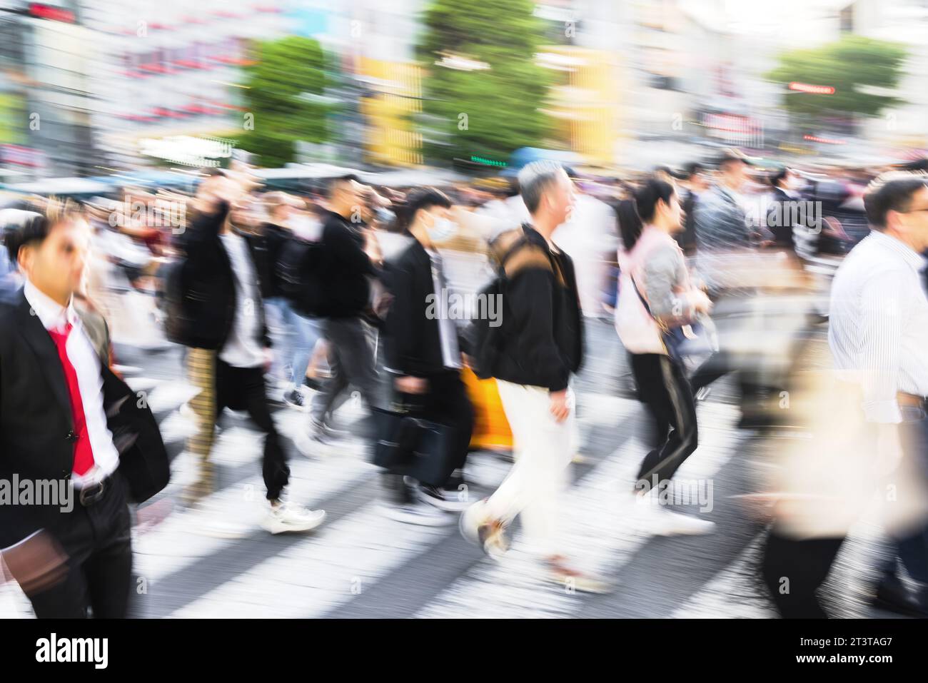 picture with motion blur effect of crowds of people crossing the famous ...