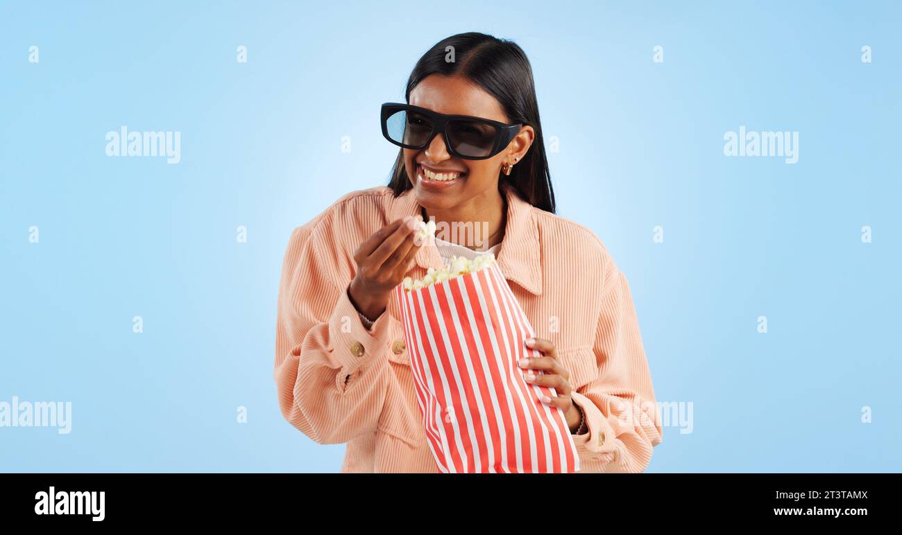 Woman, comedy film and 3D glasses with popcorn, streaming and entertainment with vision on blue background. Cinema corn snack, funny movie with user Stock Photo