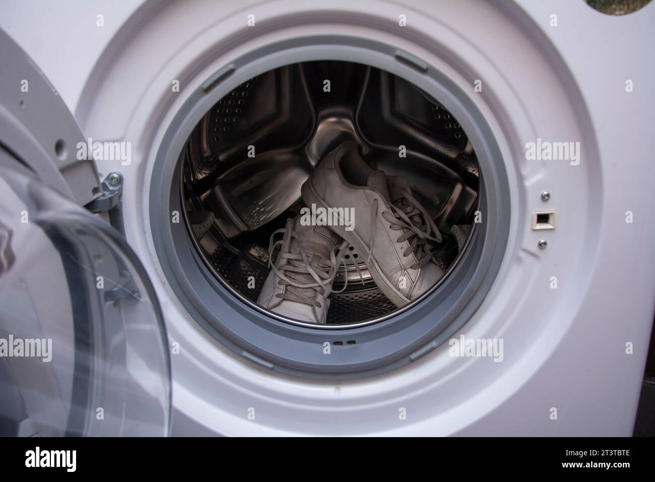 Dirty old sneakers waiting to be washed in the washing machine Stock Photo