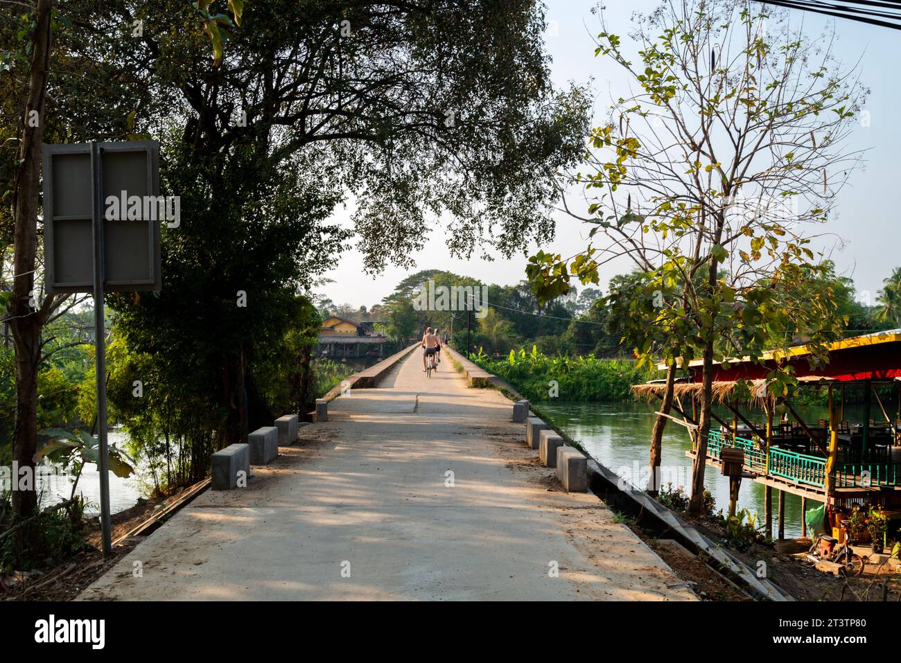 Looking towards Don Khon Island,along the French colonial bridge,a popular landmark and sunset viewpoint,for tourists to cross by foot or bicycle,or r Stock Photo