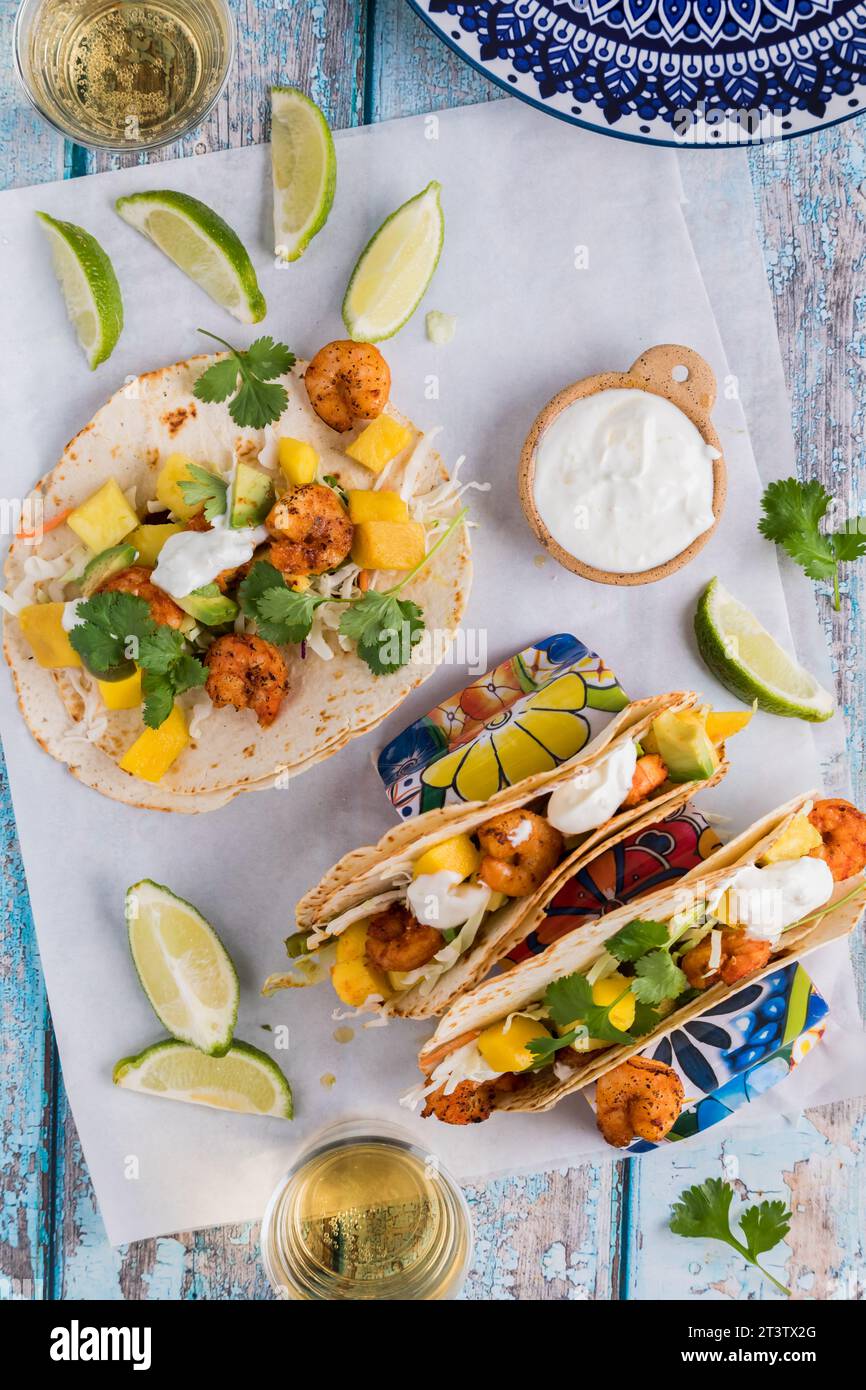 Homemade spicy shrimp tacos with lime yogurt sauce and garnished with