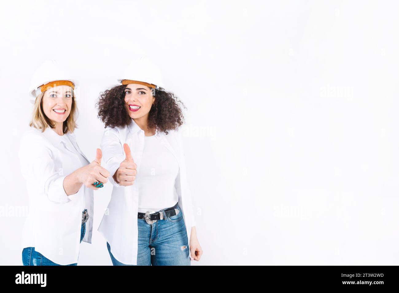 Female engineers gesturing thumb up Stock Photo - Alamy