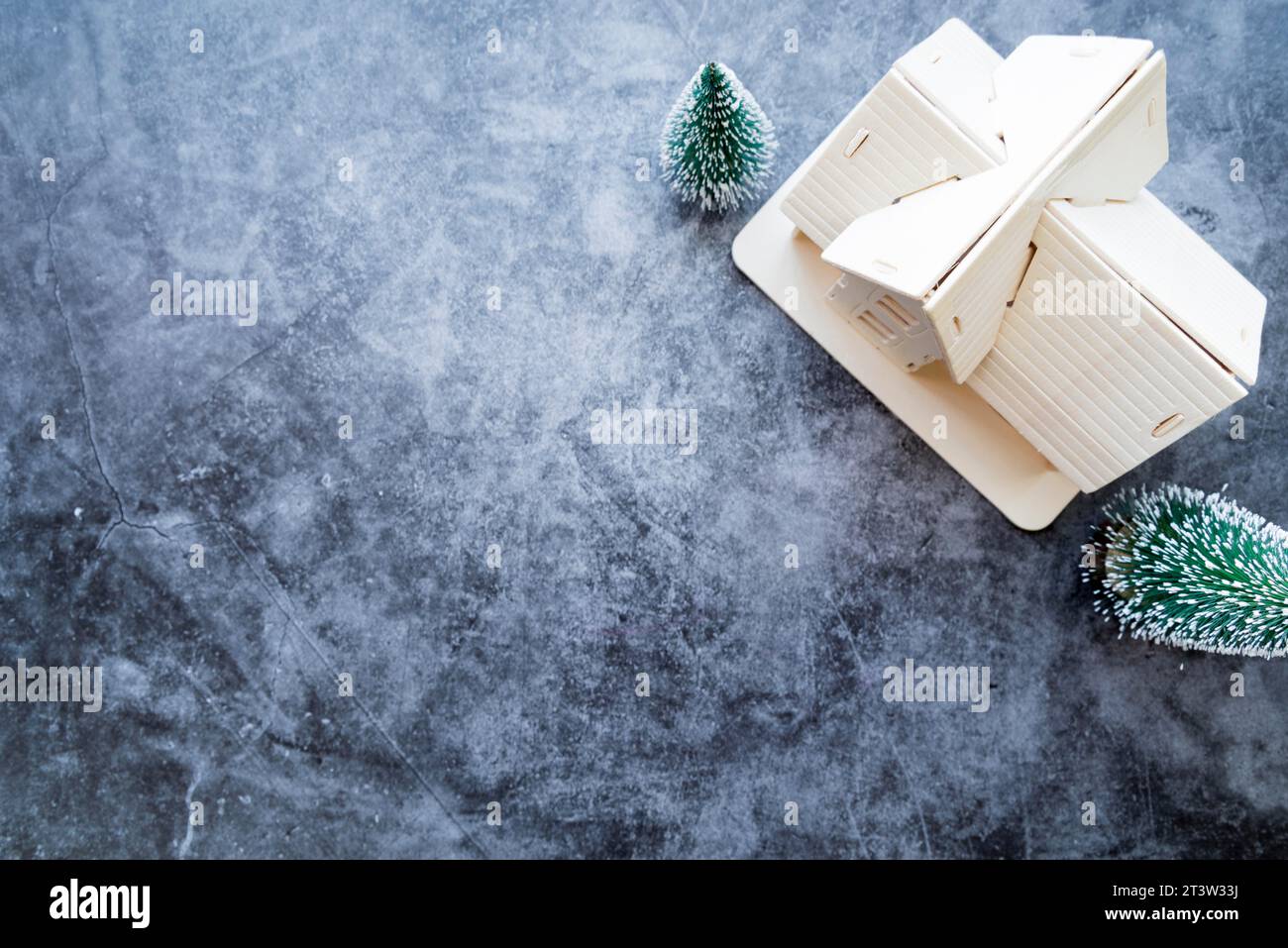 Overhead view house model with christmas tree weathered concrete background Stock Photo