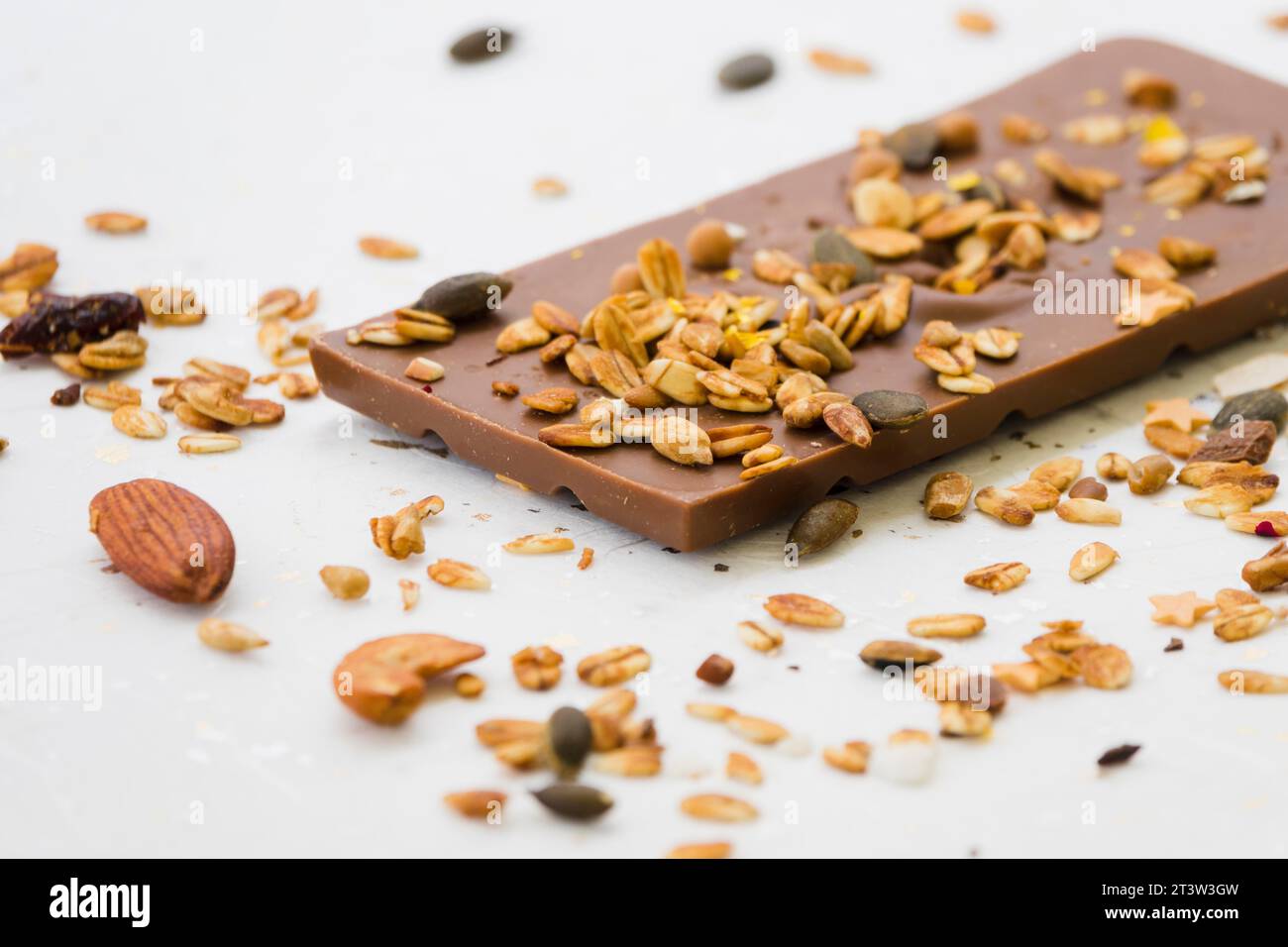 Spread dried fruits chocolate bar against white backdrop Stock Photo