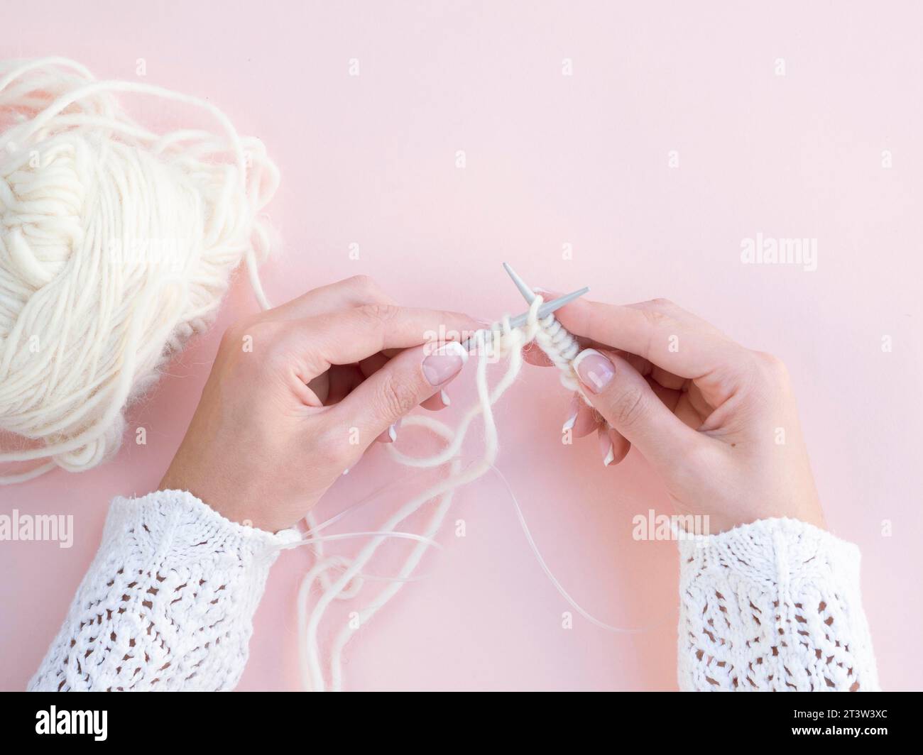 Top view woman crocheting white wool Stock Photo