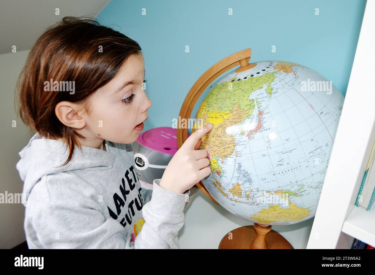 Girl holding the Planet Earth. Future Concept. Close-up portrait of a cute young girl holding globe at the park. High quality photo Stock Photo