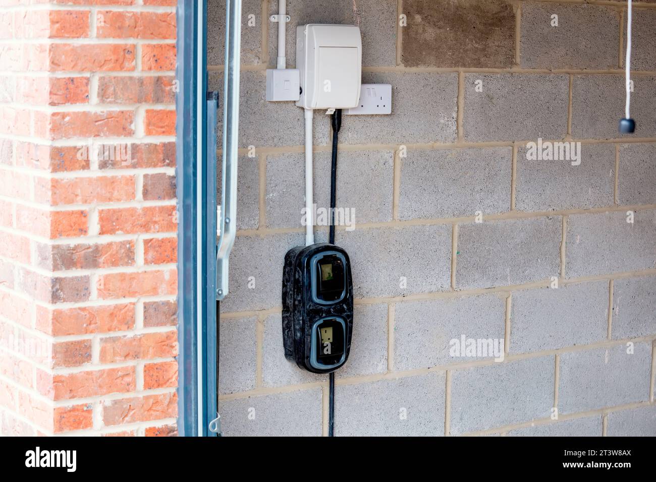 Electric vehicle domestic charging point installed outside of the house on new housing