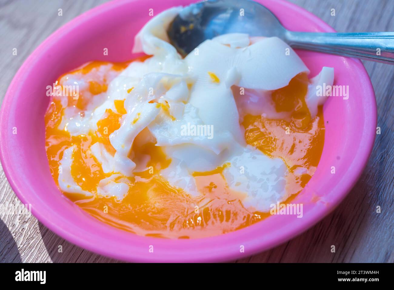 Three quarters cooked egg on a plate, with runny yolk and slightly firm